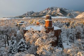 The majestic, snow-covered Flatirons is a breathtaking backdrop with Old Main at the University of Colorado at Boulder in the foreground. (Photo by Casey A. Cass/University of Colorado)